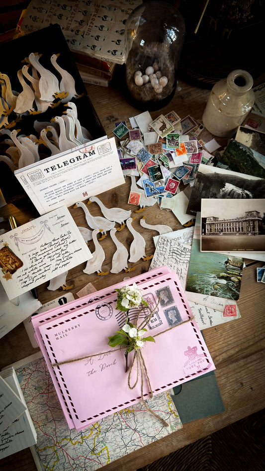 Collection of vintage letters, postcards, and stamps on a wooden surface